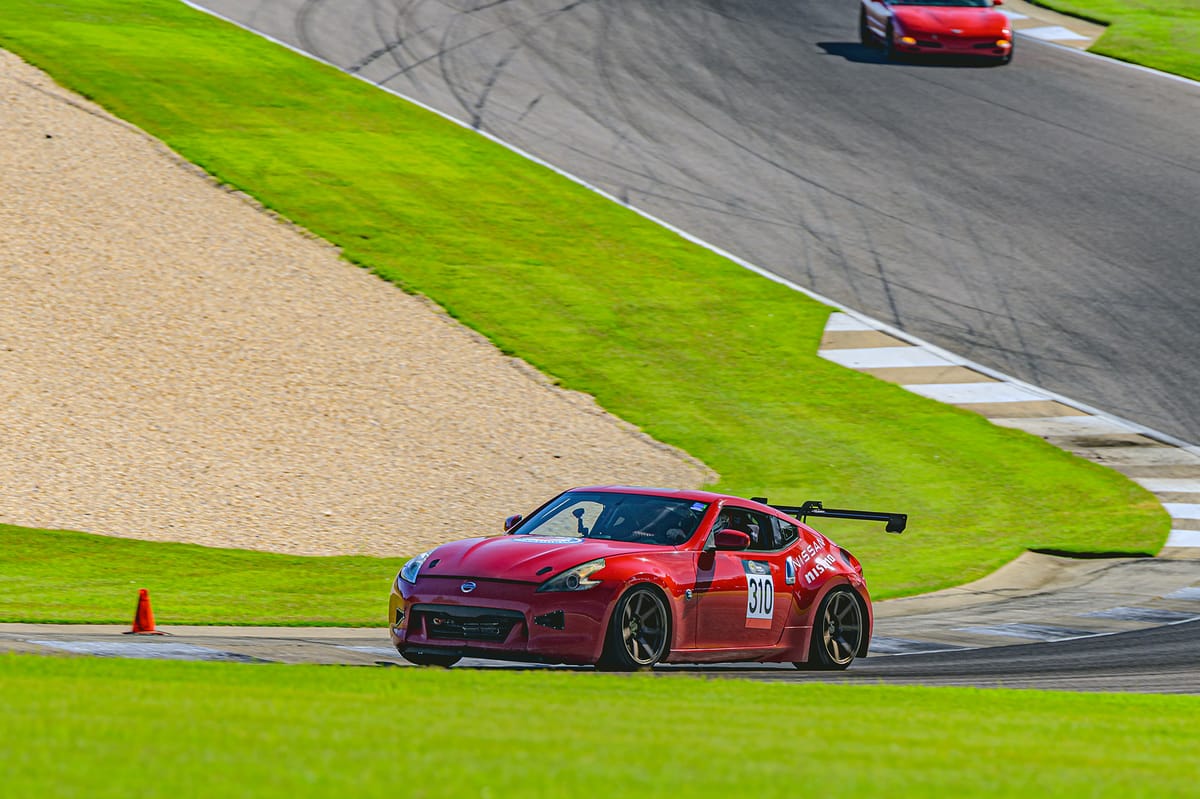 Plan Z Motorsports' red 2011 Nissan 370Z endurance racer on track